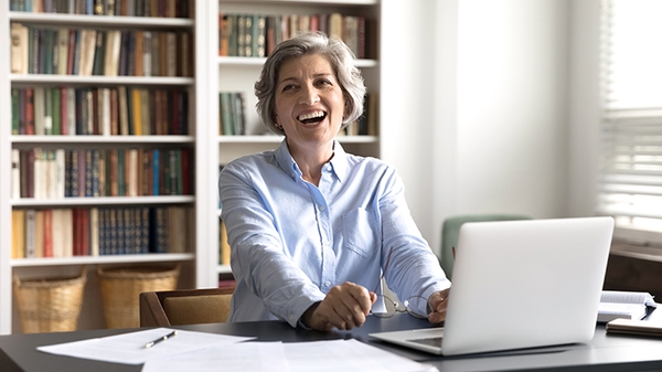 Happy businesswoman laughing in her office
