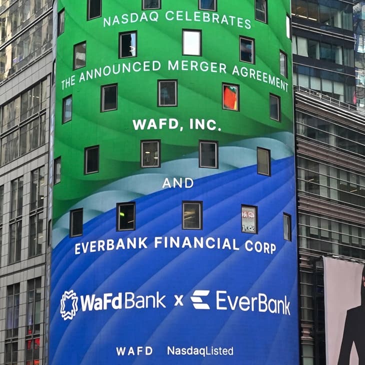 Digital billboard announcing the merger agreement between WaFd Bank and EverBank in Times Square.