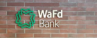 WaFd Bank sign on a brick wall.