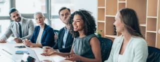 Team of businesspeople sitting together at a meeting in the office.