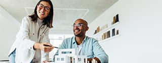 Colleagues looking at an architectural model.