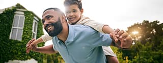 Father flying son on his back.