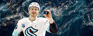 Hockey player holding a WaFd Seattle Kraken debit card.