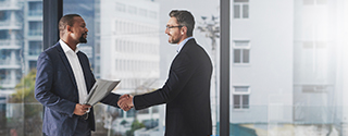 Two businessmen shaking hands at work.