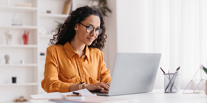 Businesswoman sitting in an office with a laptop