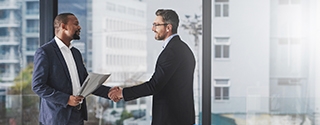 Two businessmen shaking hands at work.