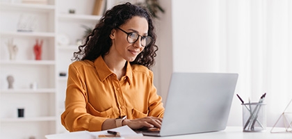 Businesswoman sitting in an office with a laptop