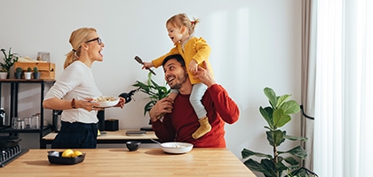 Family playing while cooking in the kitchen.