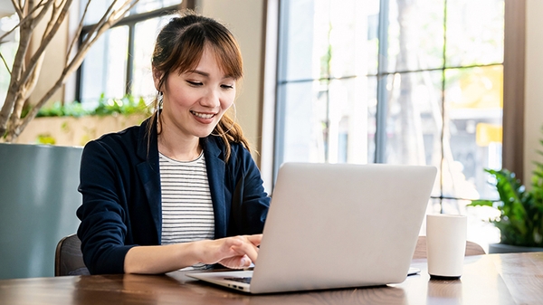 Businesswoman working on laptop at office desk