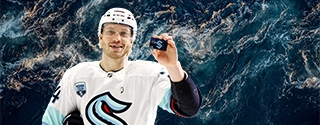 Hockey player holding a WaFd Seattle Kraken debit card.