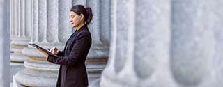 Female lawyer in front of the courthouse.