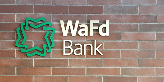 WaFd Bank sign on a brick wall.