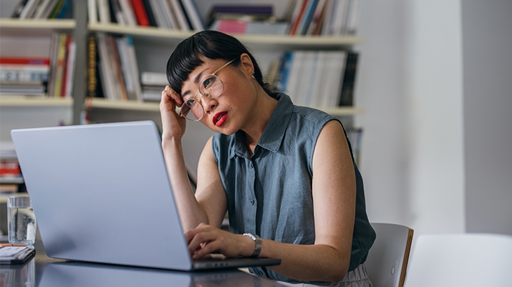 Frustrated woman looking at a laptop.