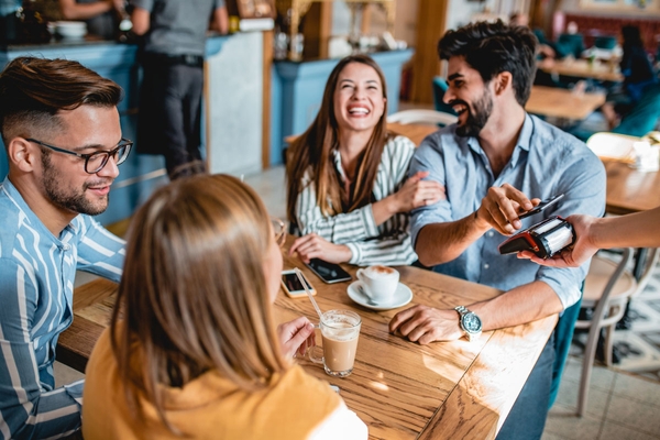 Customers using contactless payment services at a restraunt