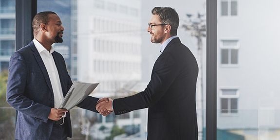 Two businessmen shaking hands at work