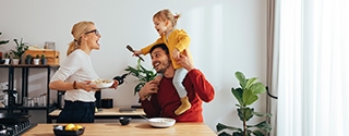 Family playing while cooking in the kitchen.