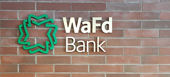 WaFd Bank sign on a brick wall.