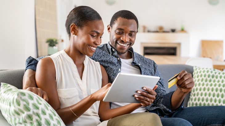 Couple using a credit card for online shopping