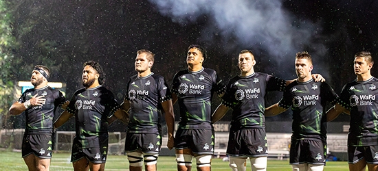 Seawolves team standing together on field.