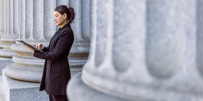 Female lawyer in front of the courthouse.