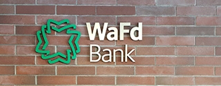 WaFd Bank sign on a brick wall.