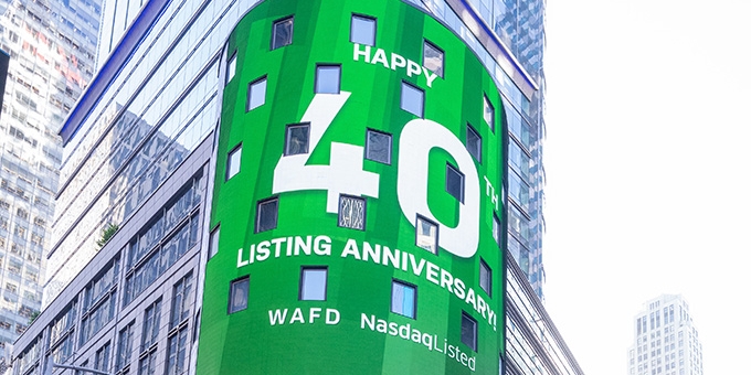 WaFd employees in Times Square NYC with WaFd Nasdaq sign