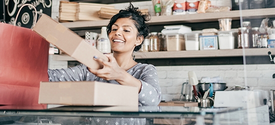 A young business owner packaging products.