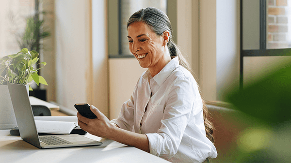 Businesswoman in office using phone