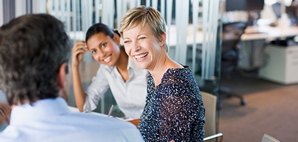 Women smiling in business meeting