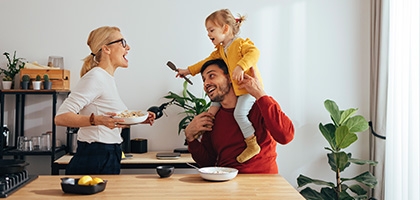 Family playing while cooking in the kitchen.