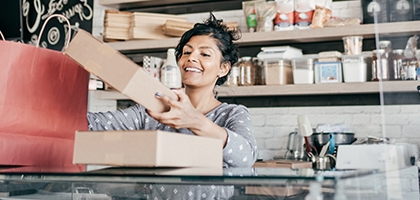 A young business owner packaging products.