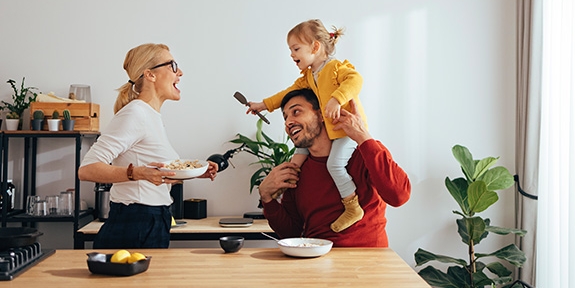 Family playing while cooking in the kitchen.