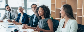 Team of businesspeople sitting together at a meeting in the office.