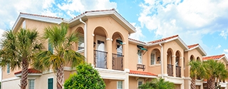 Senior housing building with tropical trees on a sunny day.