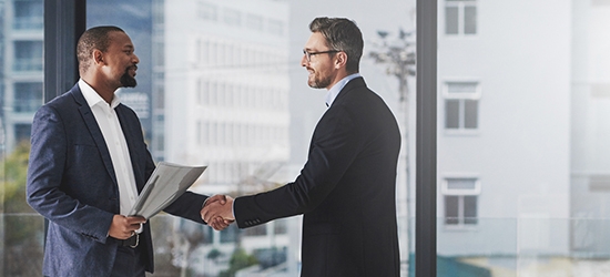 Two businessmen shaking hands at work