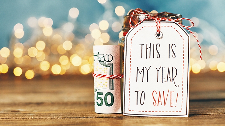 Money tied in string and holiday gift tag saying "This is my year to save!"