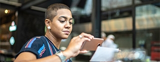 Woman depositing check with a mobile phone.