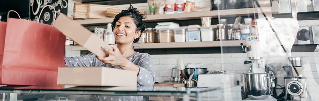 A young business owner packaging products.