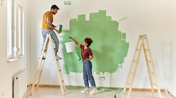 Couple painting their walls during a home renovation.
