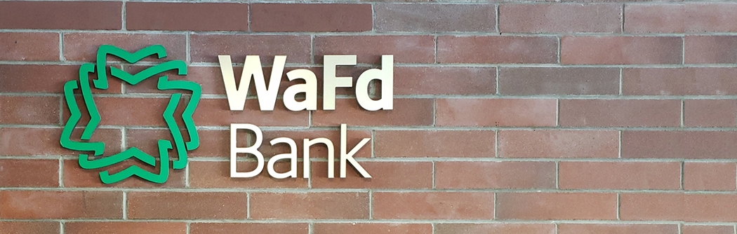 WaFd Bank sign on a brick wall.