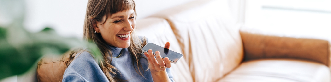 Cheerful woman speaking on a cellphone.