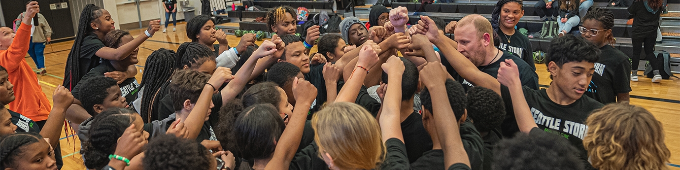 Seattle Storm team high-five at Denali Basketball Clinic.