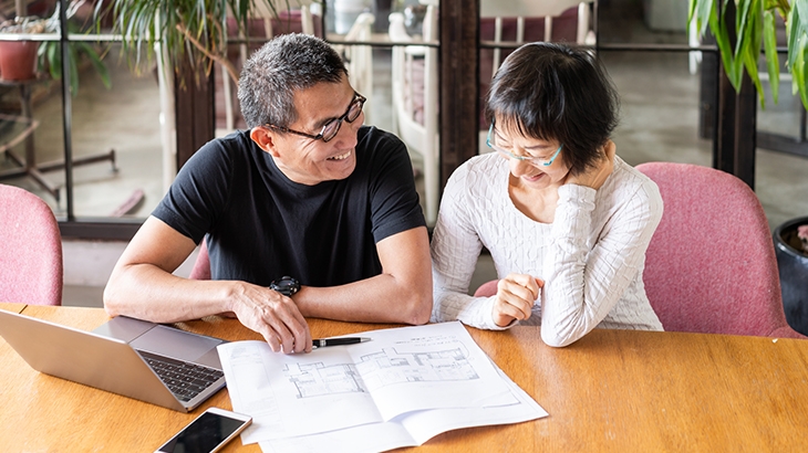 Couple talking about the floor-plan of their new house