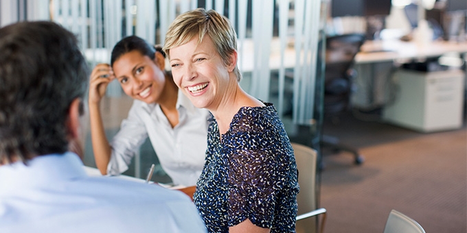 Women smiling in business meeting