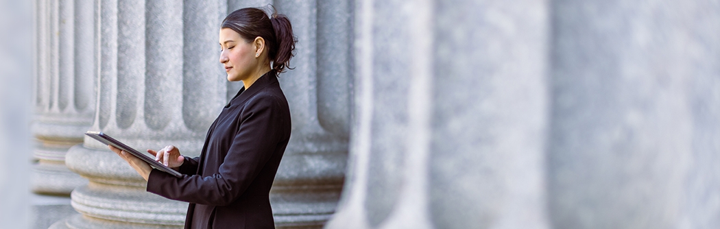 Female lawyer in front of the courthouse.