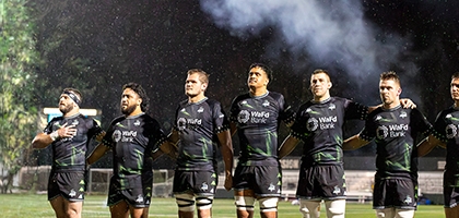 Seawolves team standing together on field.