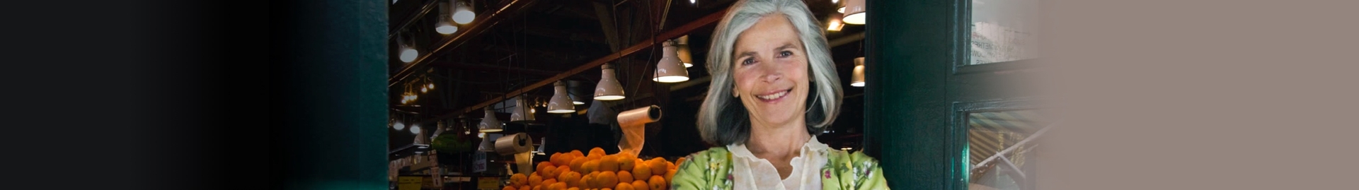 Small Business owner standing infront of a store