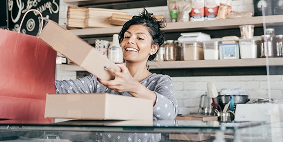 A young business owner packaging products.