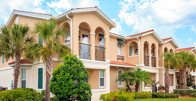 Senior housing building with tropical trees on a sunny day.