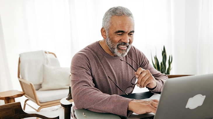 Man using laptop at home.